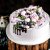 close-up-of-creamy-cake-in-lilac-decorated-with-lilac-pink-decorations-and-grape
